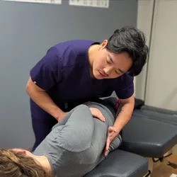 Chiropractor Ellicott City MD Jonathan Boebinger Adjusting Patient Back